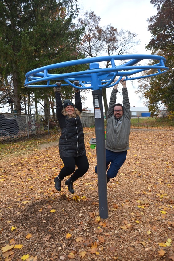 Mayor Deb Gilvesy and Councillor Chris Parker try out playground equipment in Elliott Fairbairn Park.